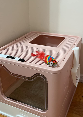 the pink litter box with a top exit