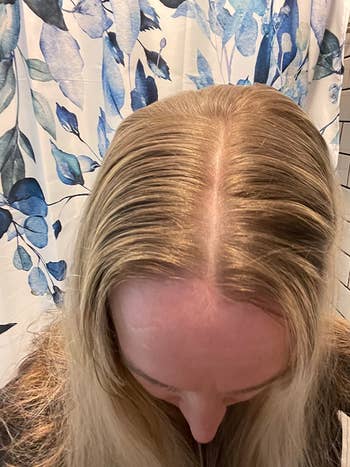 Person looking down, showing hairsbreadth  parting. Background features a ablution  curtain with leafage  pattern. Suitable for hairsbreadth  attraction   merchandise  promotion