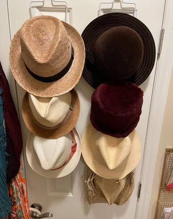 a different reviewer's wide brim hats hanging on the rack