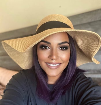 reviewer selfie, smiling wearing floppy hat