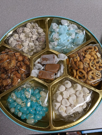 Reviewer image of interior of product with blue and white jelly beans, marshmallows, pretzels, blue taffy, caramel
