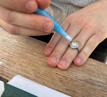reviewer using the blue cleaning stick to clean their ring
