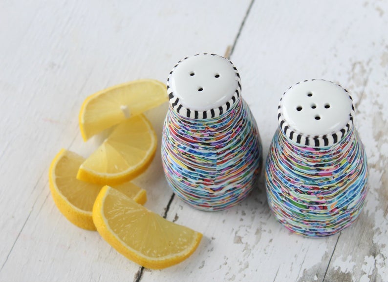 colorful ceramic salt and pepper shakers with white tops and striped trim