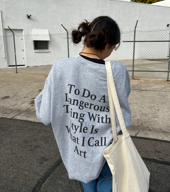 back of the pullover with black text that reads 