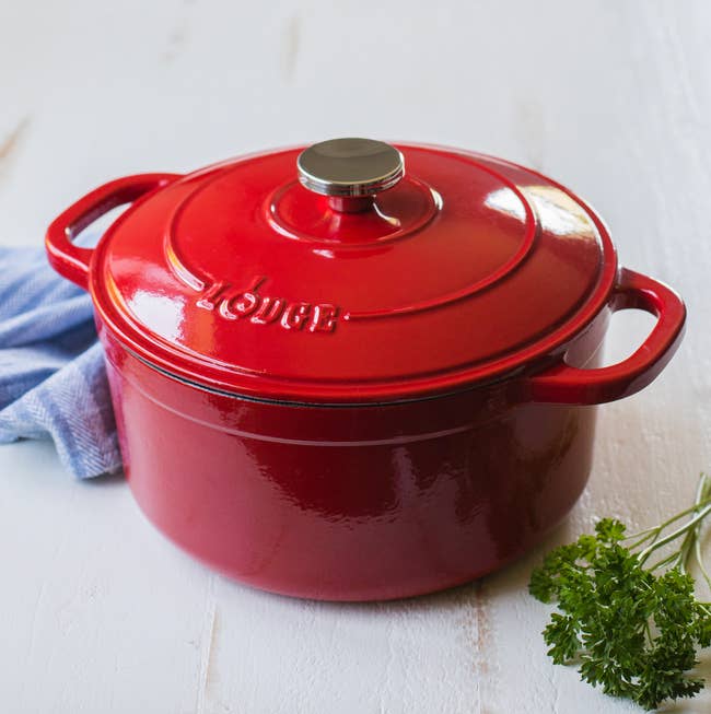 A cast iron dutch oven in red