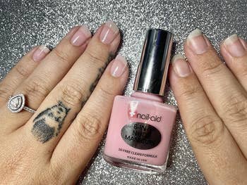 Close-up of hands, one with nail concealer and one without