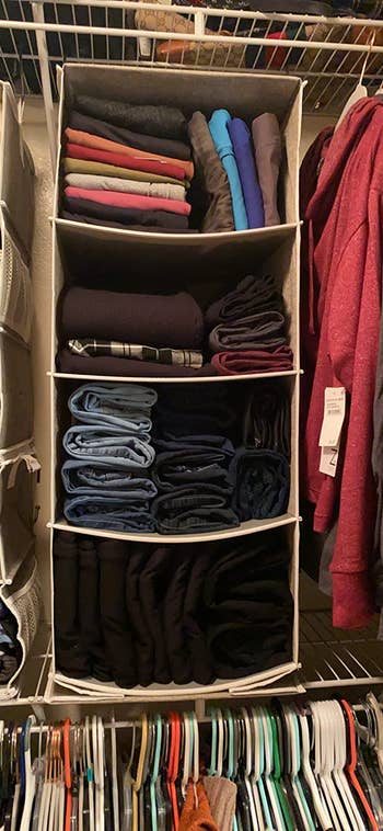 reviewer hanging closet organizer with folded clothes