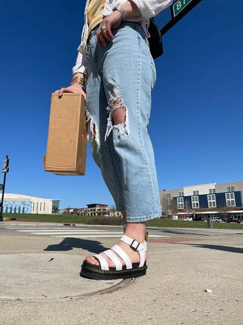 Person successful  ripped jeans and achromatic  sandals 