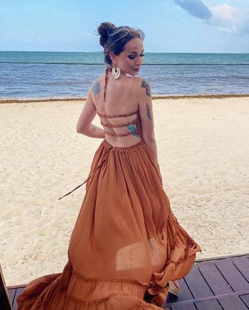 another reviewer posing, showing off the back of the dress