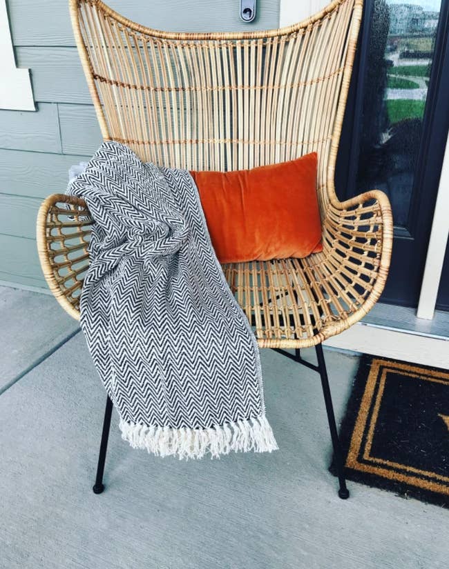 reviewer's blanket on a wicker chair outside
