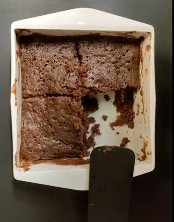 Reviewer image of cooked brownie in white square shaped silicone container 