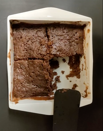 Reviewer image of cooked brownie in white square shaped silicone container 