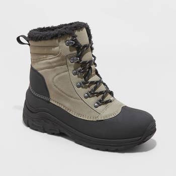 a khaki and black snow boot with faux fur lining
