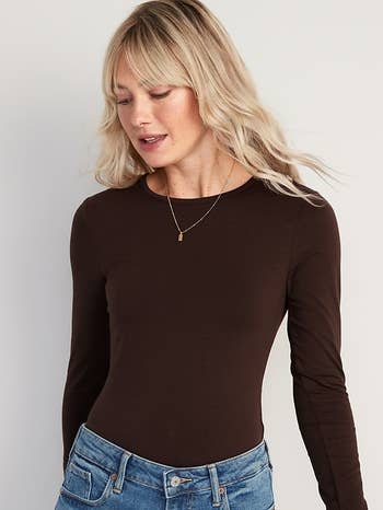 model wearing the brown bodysuit with a pair of jeans