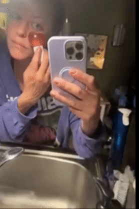 Reviewer rubbing one of the ice globes under their eyes