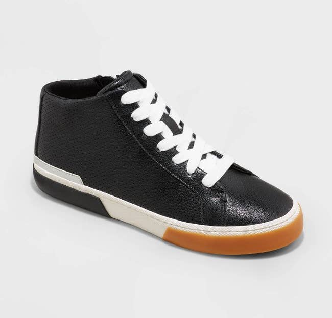 black perforated faux leather sneakers with white laces and sole and brown front of sole