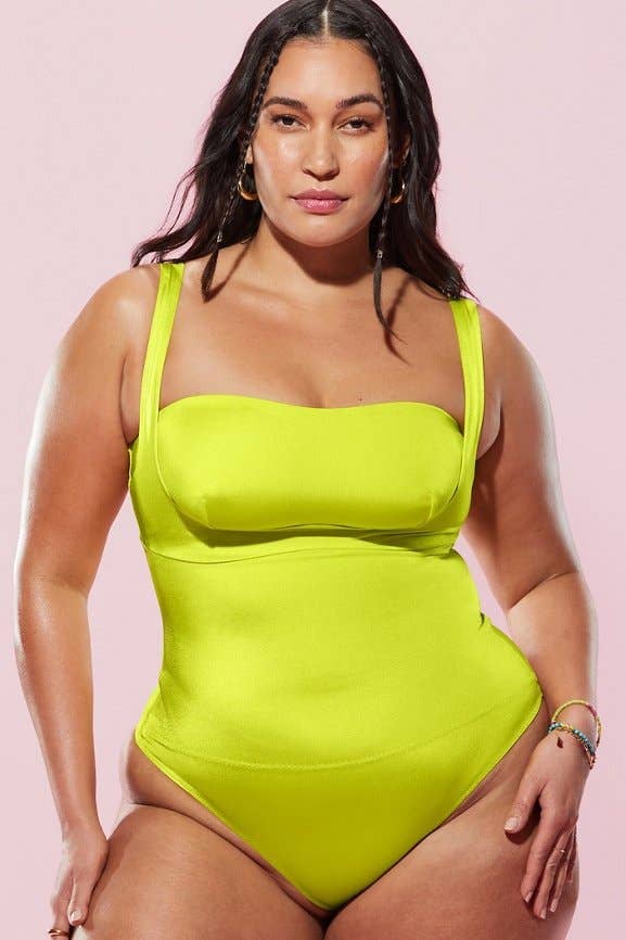 a model wearing the bodysuit in a vibrant lime green