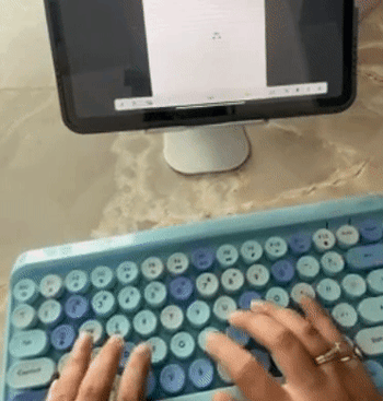 Reviewer typing on a blue version 