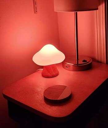 the little mushroom lamp glowing on a nightstand