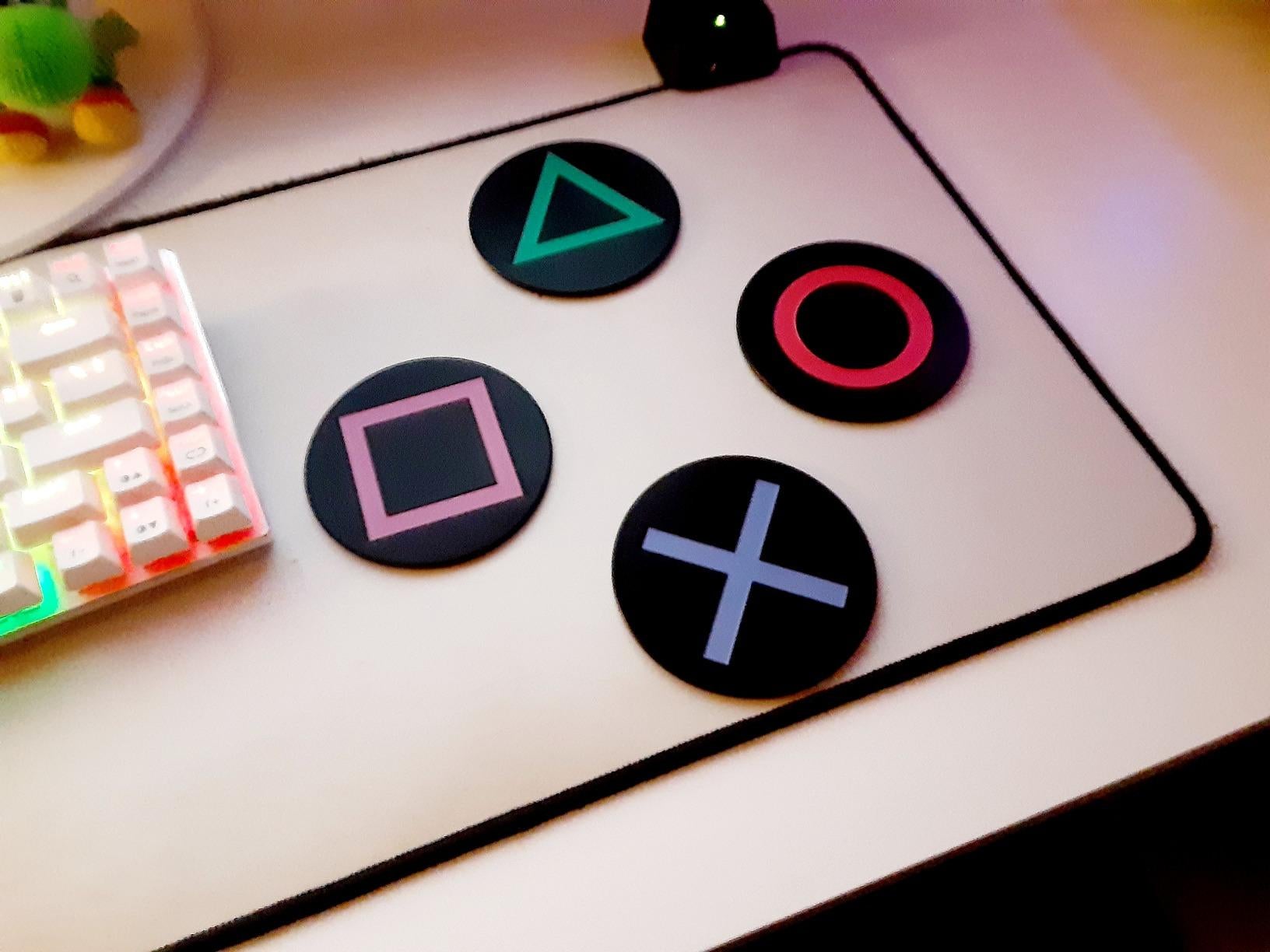 a set of playstation controller inspired coasters