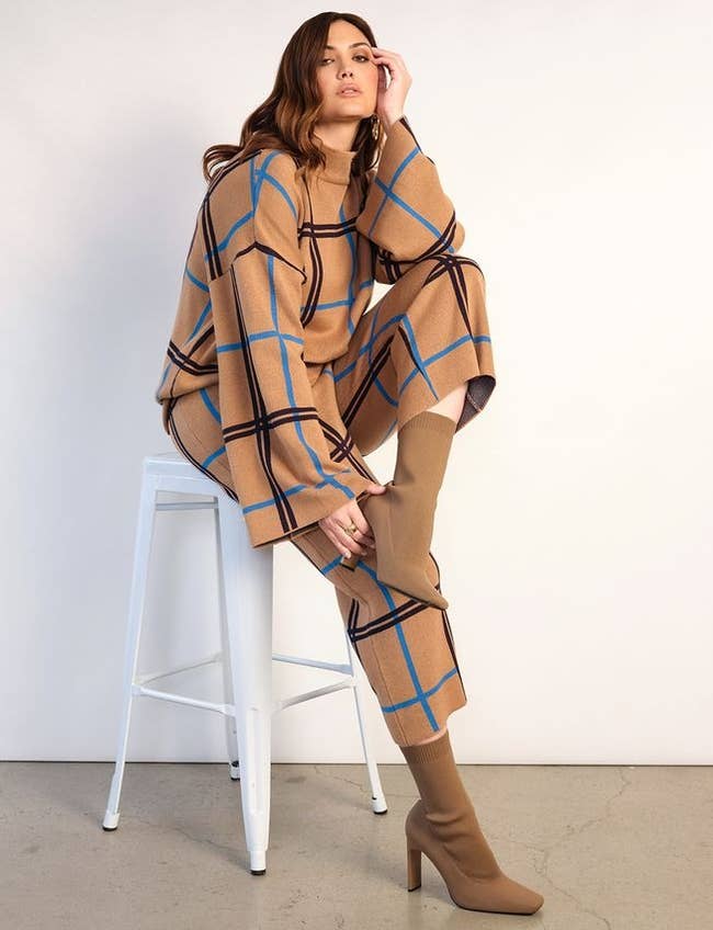 model in tan pants with blue and black windowpane print and matching sweater