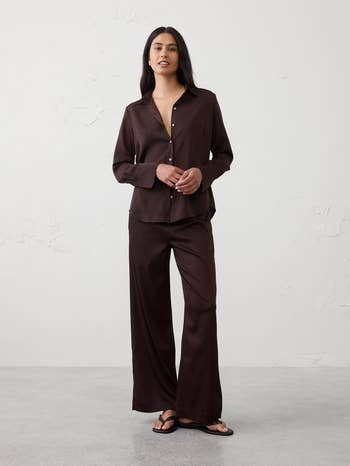 Person wearing a relaxed, button-up lounge acceptable   with agelong  sleeves and wide-leg pants, lasting  casually