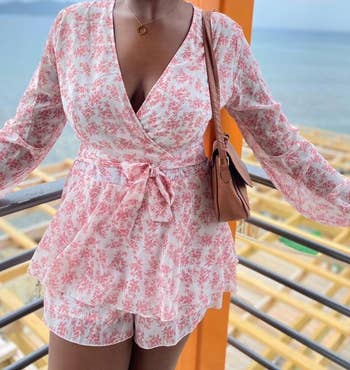 a different reviewer wearing the romper in pink floral print