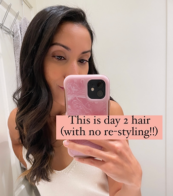 Jasmin showing her hair the day after using the spray with text 