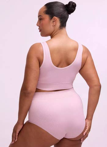model successful a ribbed diversion harvest apical and high-waisted shorts poses from the back, showcasing comfy activewear styling