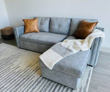 a reviewer photo of the light gray couch
