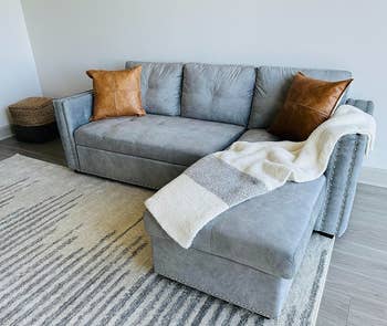 a reviewer photo of the light gray couch