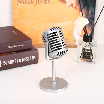 Small silver plastic retro style faux microphone