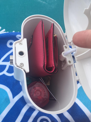reviewer showing the inside of the lock box and how a wallet easily fits inside