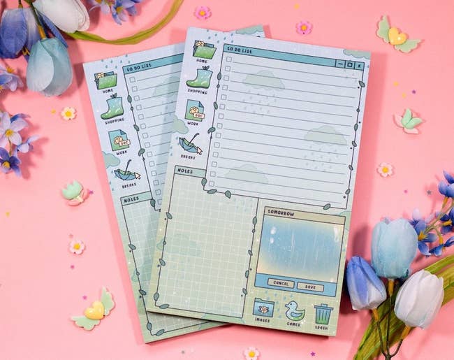 Two pastel-colored to-do database notepads with whimsical illustrations and sections for tasks, notes, and priorities. Surrounded by decorative flowers