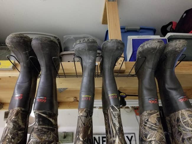 reviewer photo of wader boots hanging upside down on boot hangers