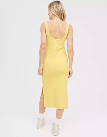 back of model wearing the yellow dress with white socks and sneakers