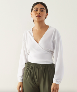 model wearing the white shirt as a wrap style