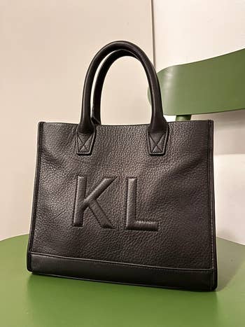 the mini top handle bag in black with two initials