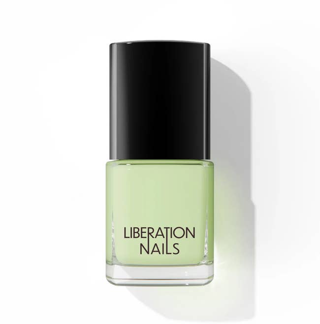 bottle of liberation nails nail polish in light green