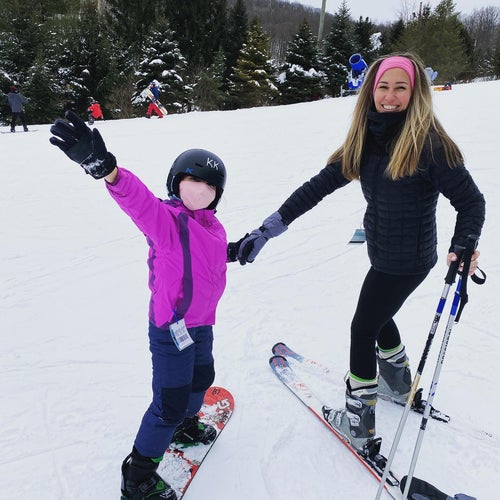 reviewer wearing leggings while skiing with child