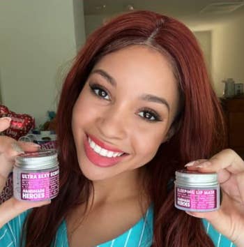 model holding two little jars of the lip mask