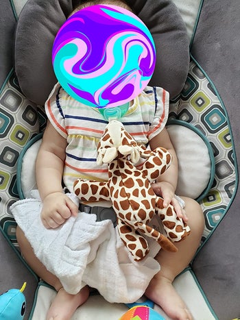 image of reviewer's child with the giraffe soothie in their mouth