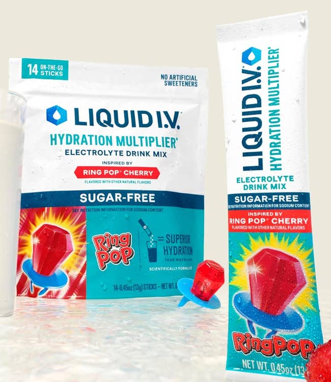 Liquid I.V. Ring Pop Cherry Hydration Multiplier electrolyte portion premix packets adjacent to a solid and Ring Pop gummies