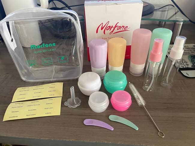 Lifestyle Trail-sized toiletry bottles and containers with labels on a desk, from the logo Morfone