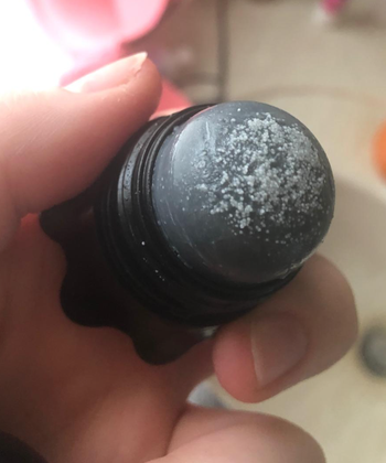 the cap off to show the salt on the top of the remover