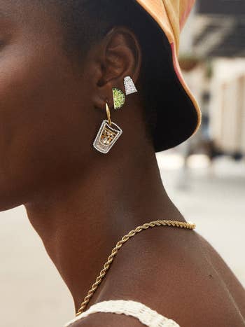 a model wearing the three earrings