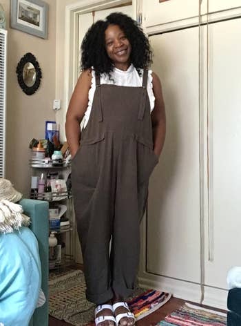 a reviewer wearing the overalls in brown 