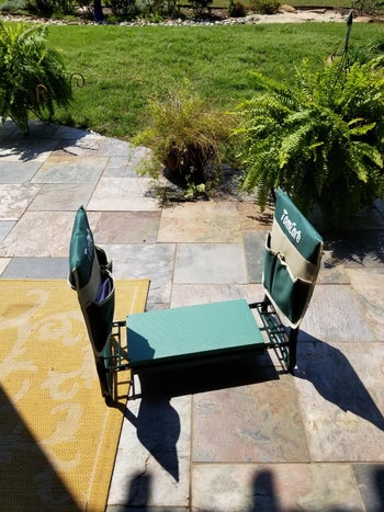 Reviewer's garden kneeler flipped for kneeling, with pockets on the sides full of their tools
