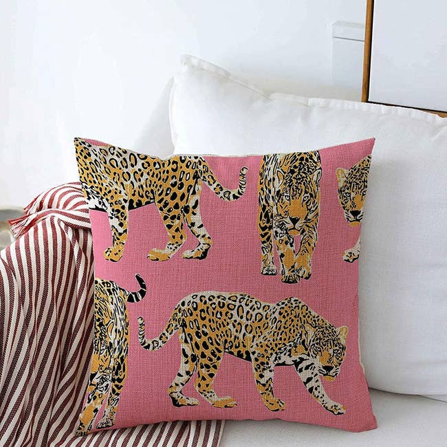 Bright pink pillow cover with cheetahs on it 