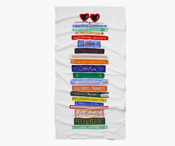 a beach towel with a design of a stack of books on them